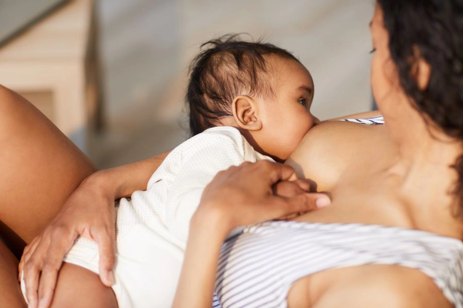 Close-up of young black mother breastfeeding baby